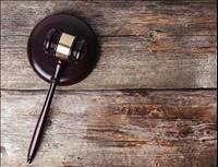 Gavel set on top of wood plank background