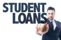 Man in a suit pointing at words "Student Loans"