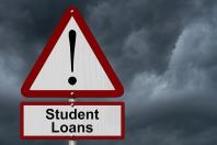 Warning sign that states "Student Loans" with storm clouds in the background